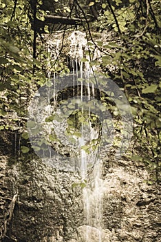 Large Waterfall from ravine in autumn, long exposure with mountains in background. slovensky raj. sucha bela trail - vintage film