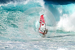 Large wave and windsurfer