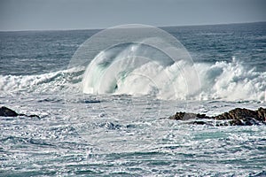 Large waves breaking at the Baiona Breakwater, Pontevedra, Spain photo