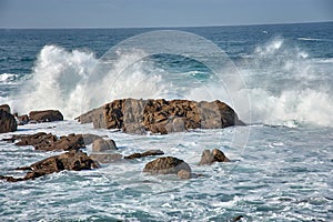 Large waves breaking at the Baiona Breakwater, Pontevedra, Spain photo