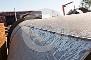 Large welded pipe lies at the base of the metal