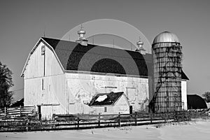 Large White Barn with Silo in Winter Snow