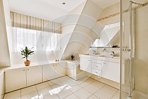 a large white bathroom with a shower and a sink