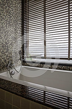 Large white bathtub in a luxurious bathroom