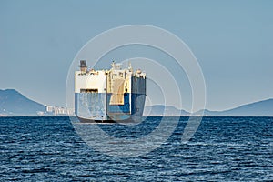 Large White and blue Roll-on/roll-off RORO or ro-ro ships or oceangoing vehicle carrier ship anchor in the open sea. Roro ship