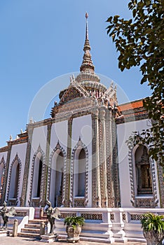 Large White Building with red roof against a blue sky at Grand Palace, Thailand