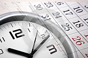 Large white clock face with calendar sheets