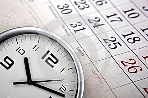 Large white clock face with calendar sheets