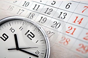 Large white clock face with calendar sheets