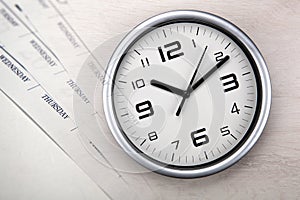 Large white clock face with calendar sheets