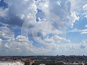 Large white clouds and blue sky over the city