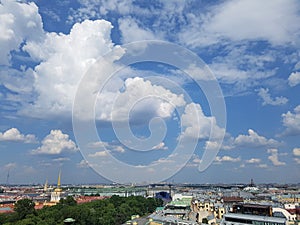 Large white clouds and blue sky over the city