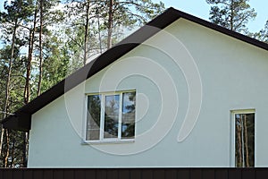 Large white concrete attic of a private house with windows b