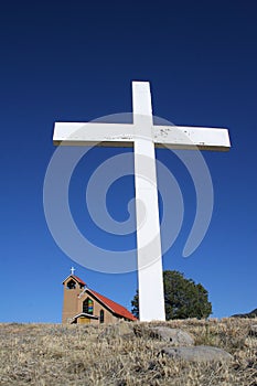 Large white cross with church