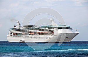 Large white cruise ship near island photo