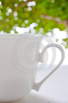 white cup of coffee on the fresh air photo