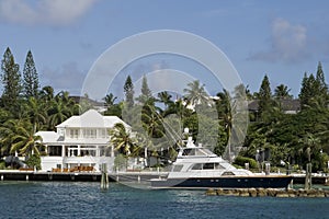 Large white home with boat in the tropics