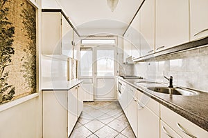 a large white kitchen with white cabinets and a sink
