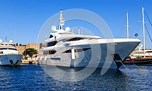 Large white modern motor superyacht in port city of Rhodes Greece