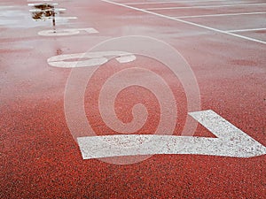 Large white numbers on court with red surface