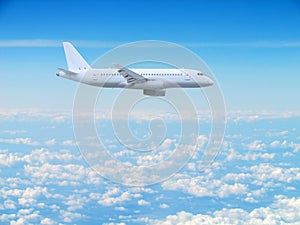 large white passenger plane flies high above the clouds