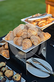 large white plate filled with buttery croissants at a delicious brunch meeting