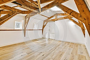 a large white room with exposed beams and wood floors