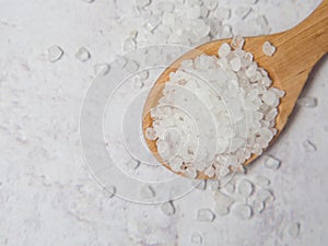 Large white sea salt in a wooden spoon
