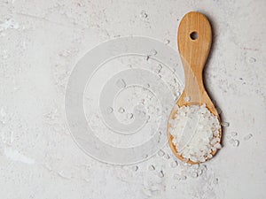 Large white sea salt in a wooden spoon