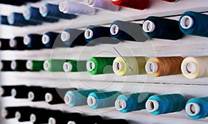 Large white stand with spools of multi-colored thread.