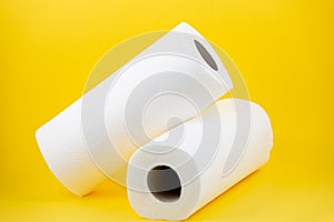 A large white toilet paper roll for use in bathrooms or kitchens, used for cleaning dirt in the bathroom on yellow background