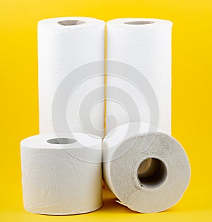 A large white toilet paper roll for use in bathrooms or kitchens, used for cleaning dirt in the bathroom on yellow background