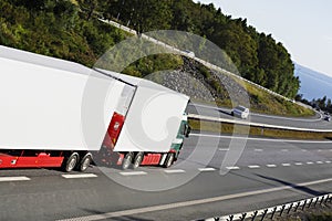 Large white truck on a scenic freeway route