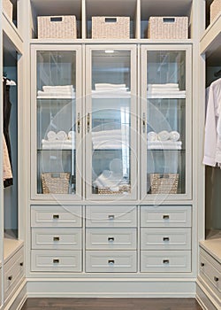 Large white walk-in closet with shelves