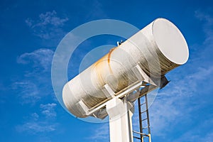 Large white water storage tank.