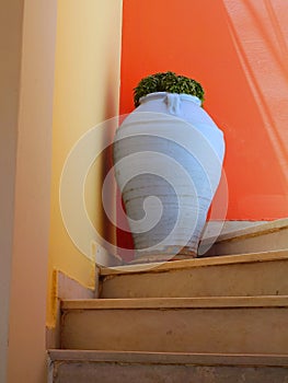 A Large Whitewashed Urn in a Stairwell