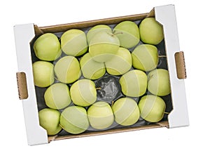 Large wholesale box of Golden Delious yellow green apples, isolated.