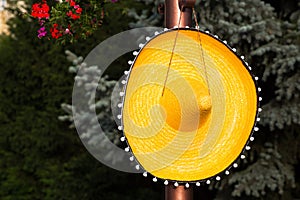 Large wide brimmed straw sombrero hanging on a peg