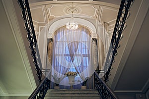 A large window with a staircase in a Baroque and classicist palace. With space to copy