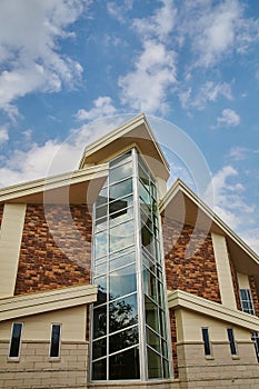 Large windowed chapel with a brick facade during the day