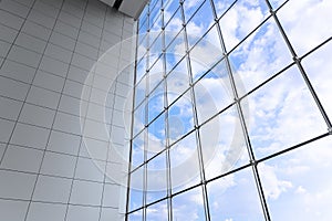 Large windows blue sky of modern business office building in metropolitan. Interior shopping mall glass frame window saving