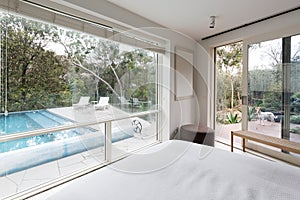 Large windows showing view to pool and garden in luxury home photo