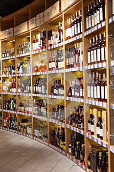 Large wine racks. Many different alcoholic beverages. Luxury enoteca. The photo is blurry photo