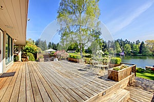 Large wood deck with lake and spring landscape.