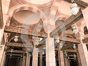 Large wooden ceiling beams, planks, ceilings under the ceiling with arches and lamps, lanterns in the Arab Islamic Mosque, a templ