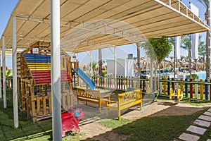 Large wooden climbing frame in children`s playground area