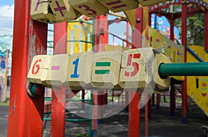 Large wooden cubes with colorful numbers on a street playground