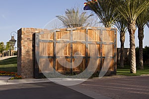 Large wooden gate to luxury home golf community