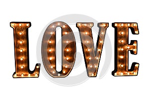 large wooden glowing letters forming the word LOVE on a white background