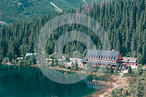 Large wooden hotel on the lake in the mountains